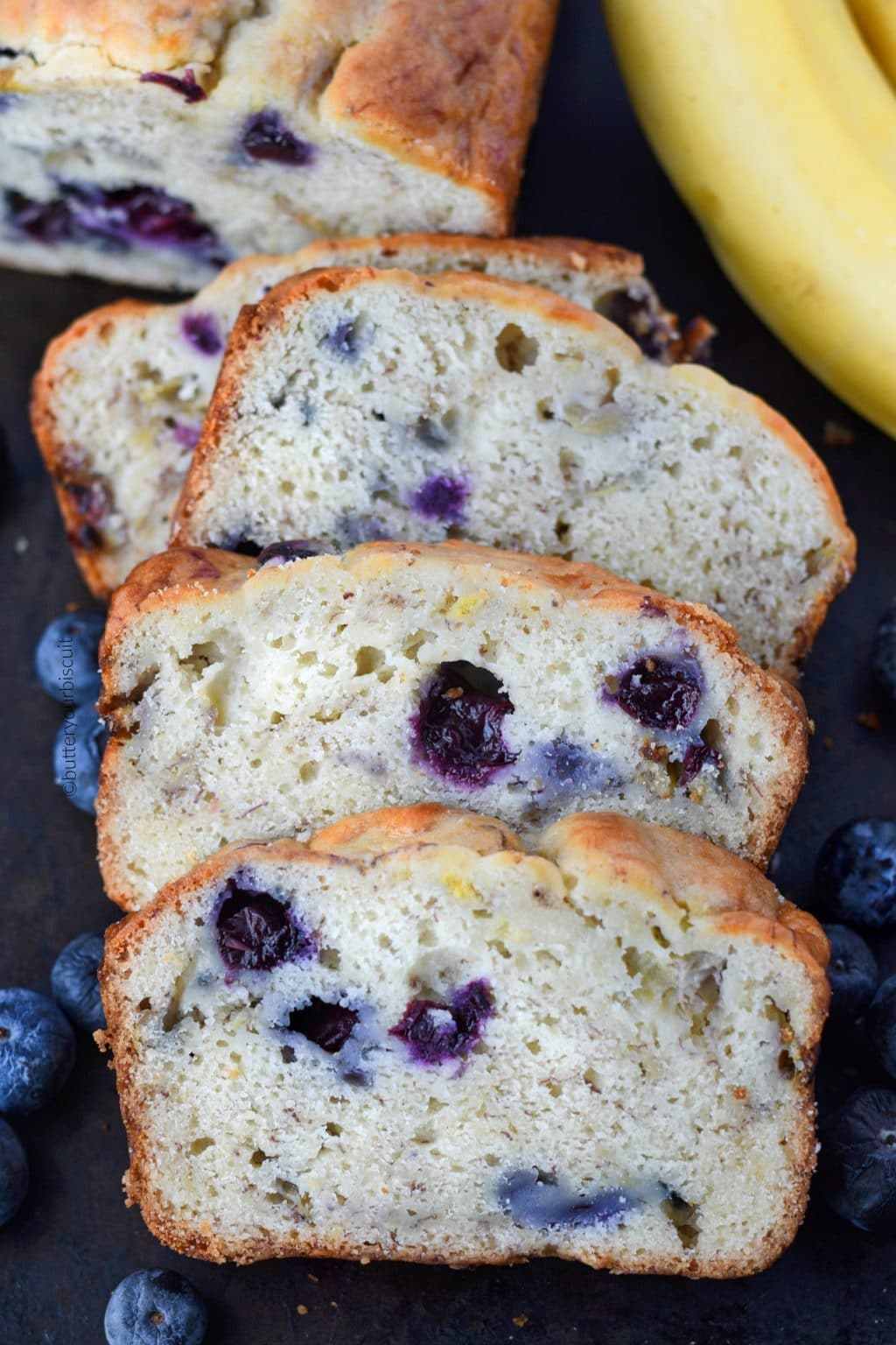 Banana Blueberry cream cheese bread on a cutting board scliced