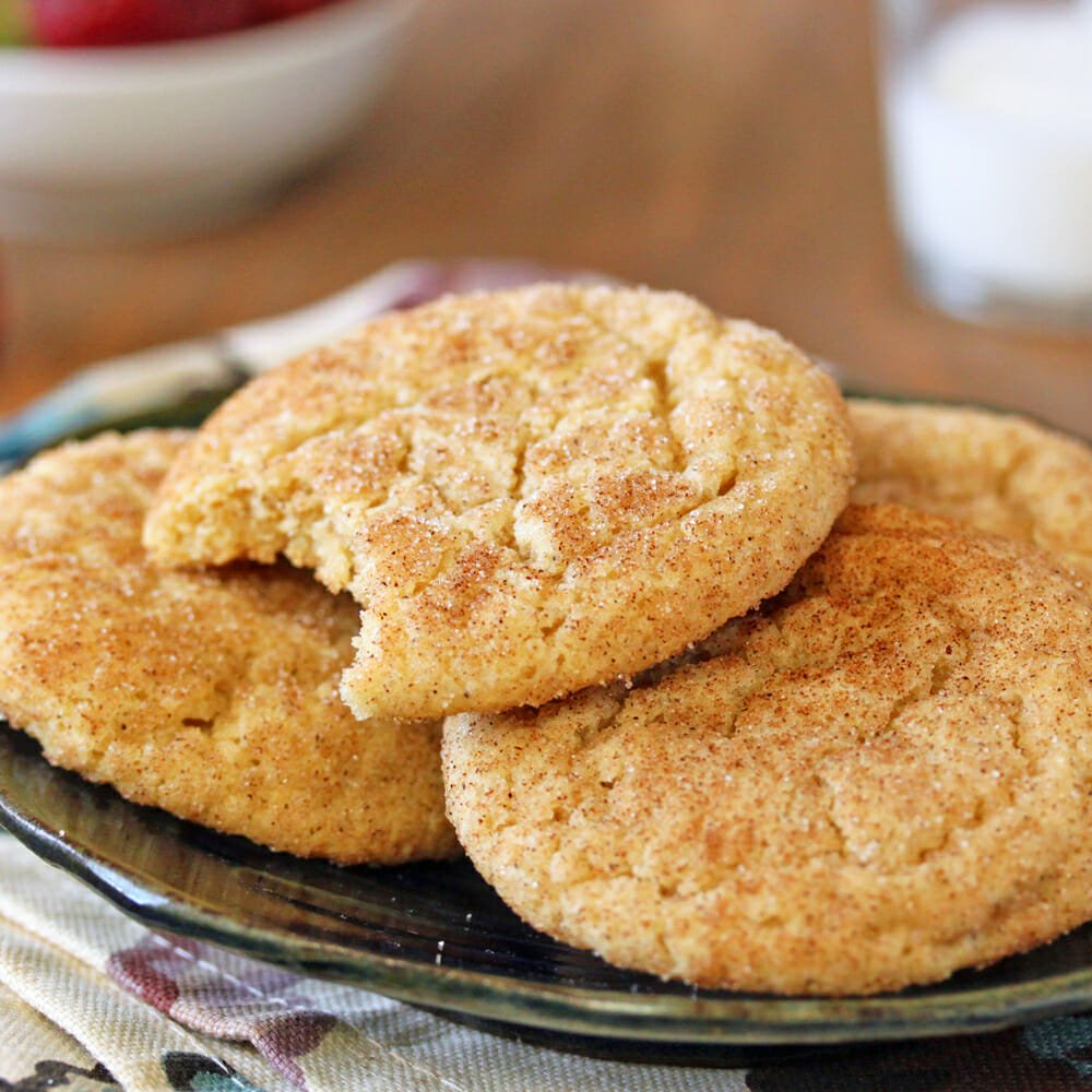 Snickerdoodle Cookies - a stack of cookies on a small plate with a bite taken from the top cookie
