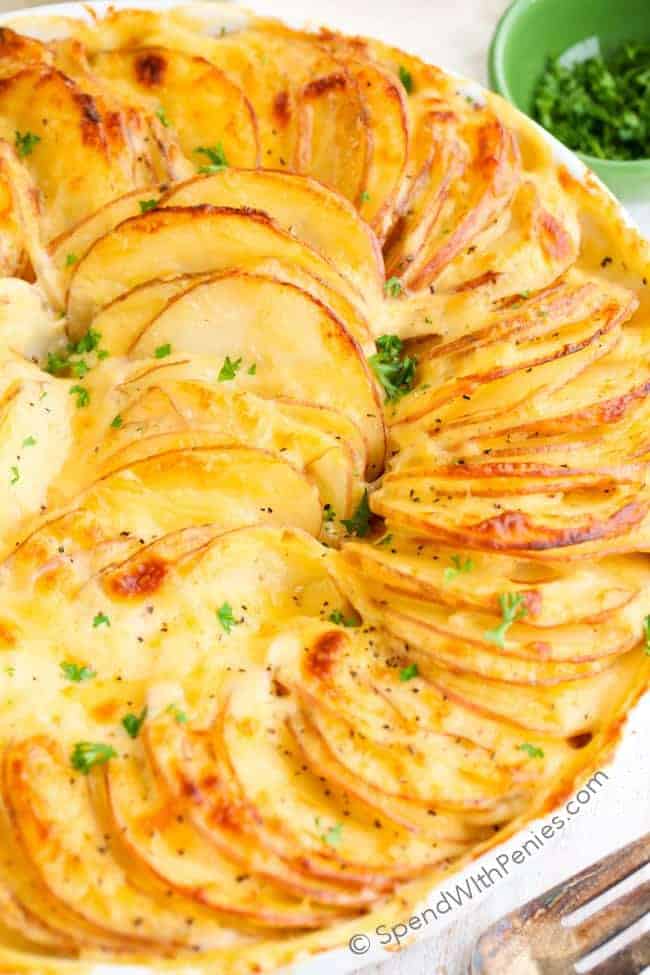 closeup of Au Gratin Potatoes with browned cheese garnished with parsley