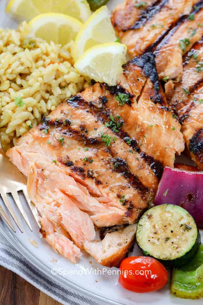 Grilled salmon on a plate with veggies and rice