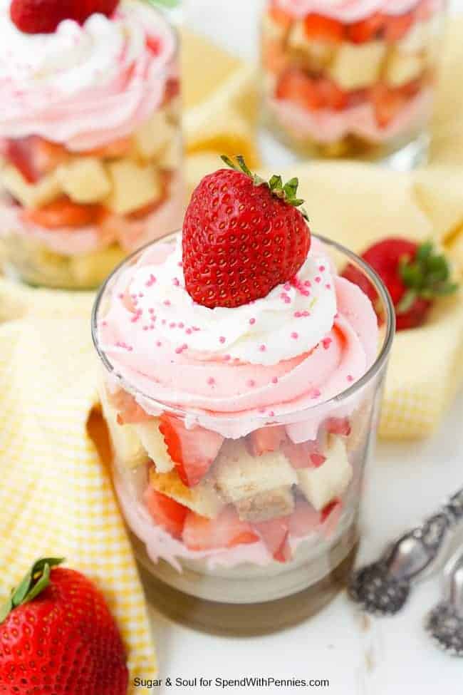 Strawberry Mousse Trifle in a clear glass on a table with yellow napkins