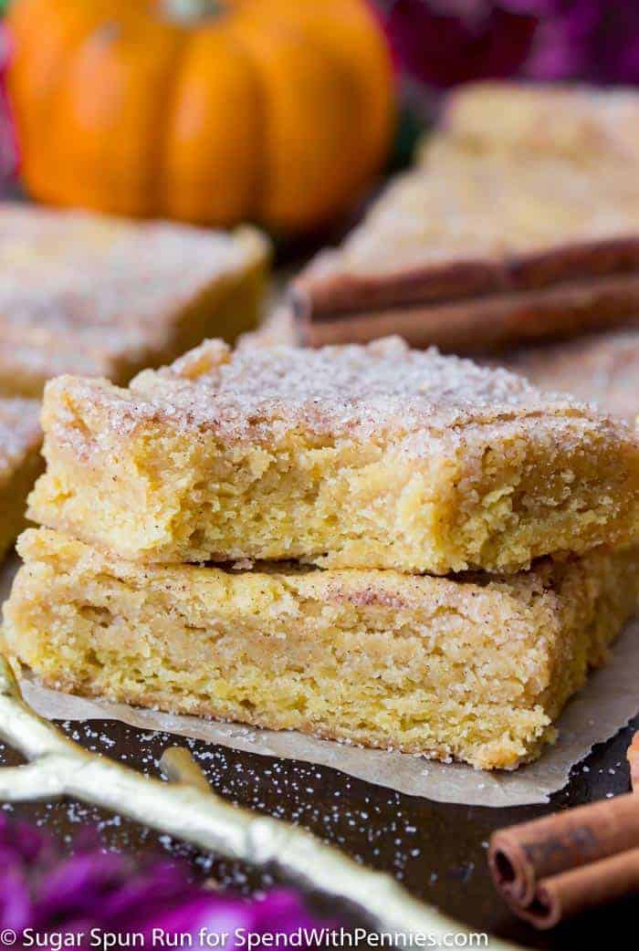 Two stacked Pumpkin Blondies, one with a bite taken out of it.