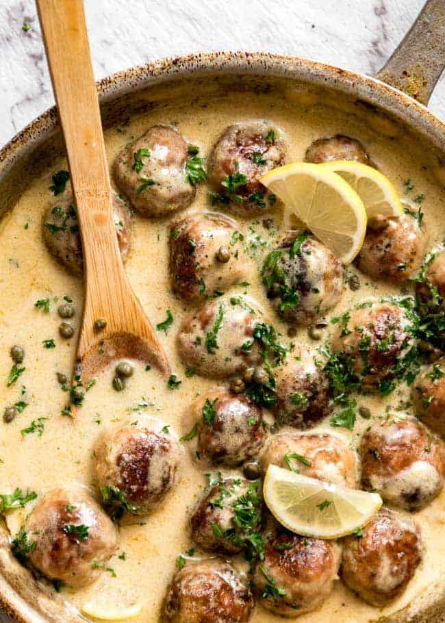 Creamy Lemon Chicken Piccata Meatballs in a pot with a spoon