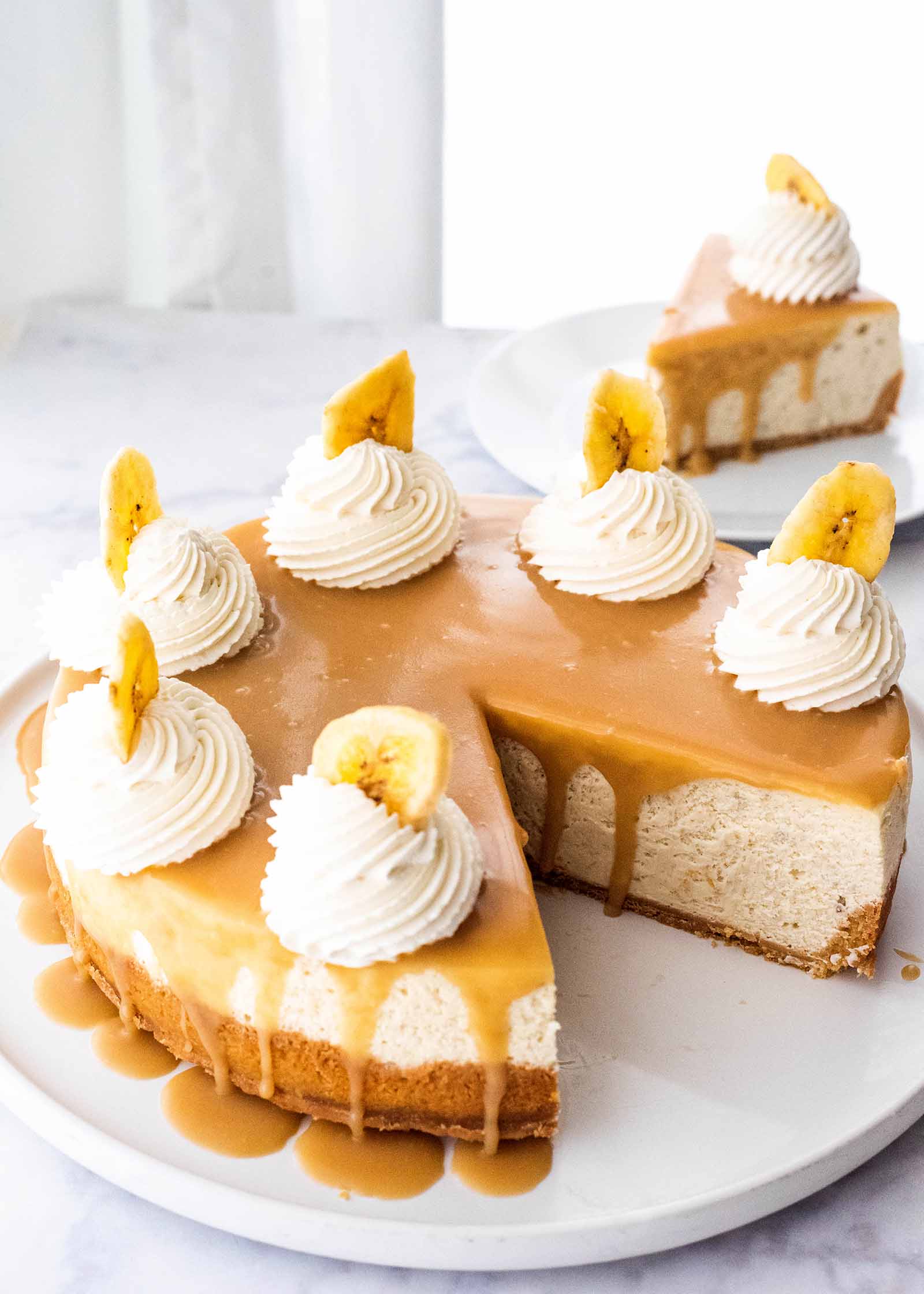 Baked Banoffee Cheesecake Pie pie with toffee sauce on platter