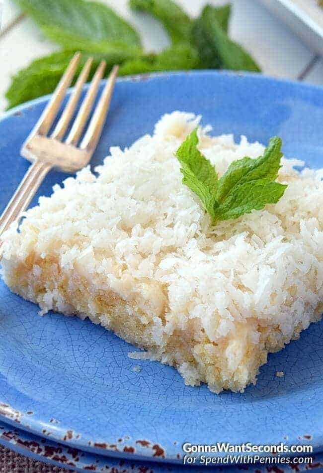 Coconut Sheet Cake on a blue plate with a fork