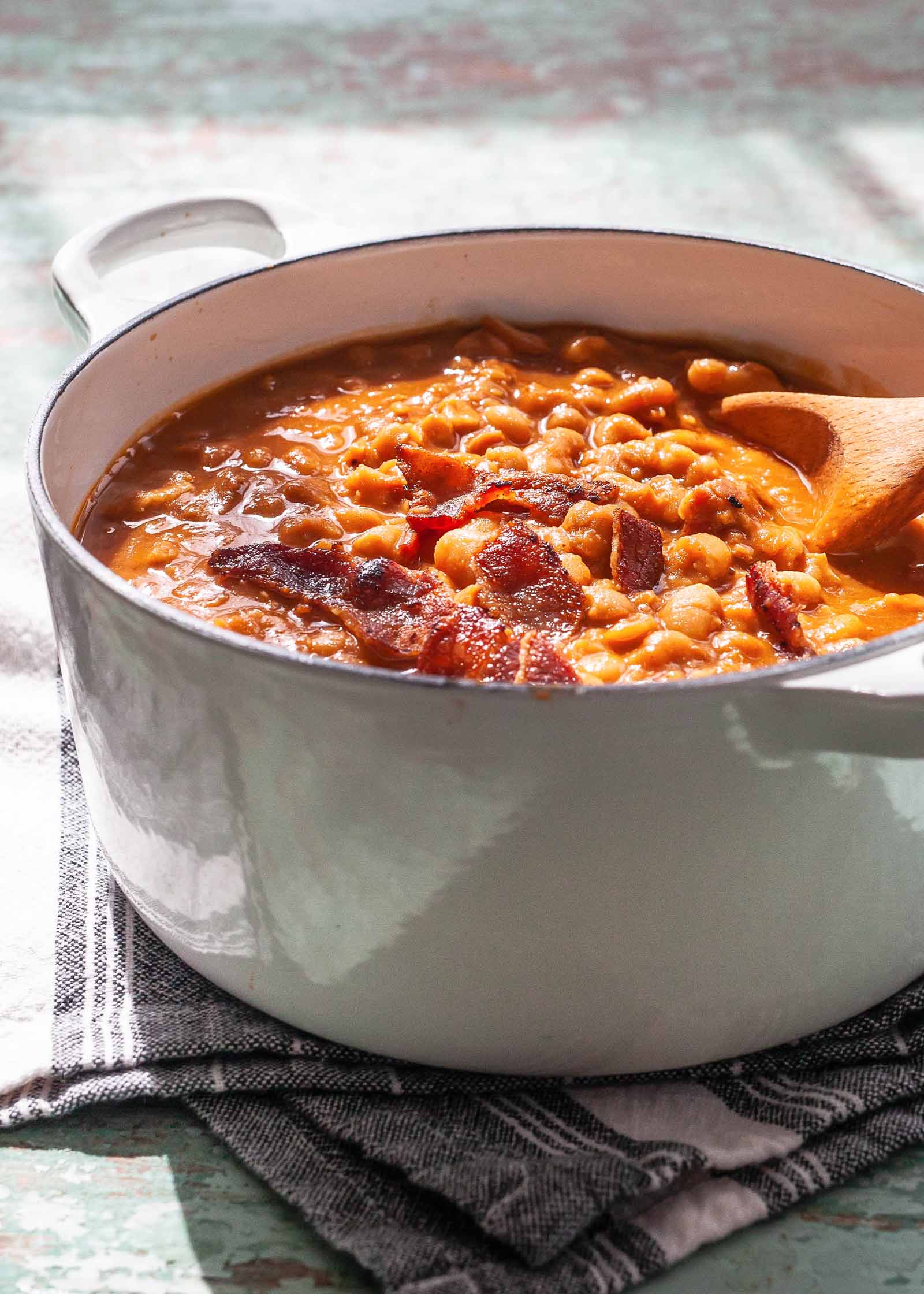 Baked Beans on the Stovetop - baked beans in a pot with a wooden spoon