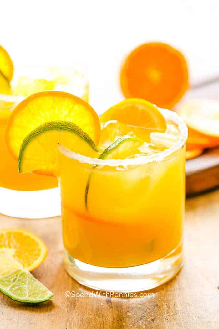 Orange Margarita in a glass with orange and lime slices