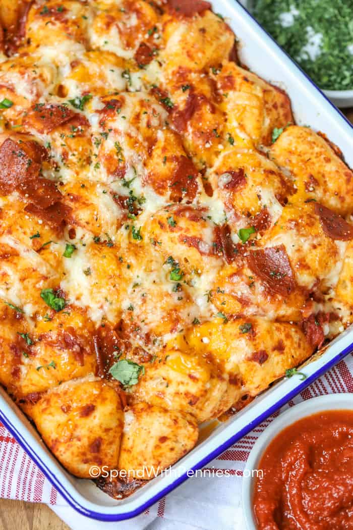 Pizza bubble bread in a casserole dish garnished with parsley