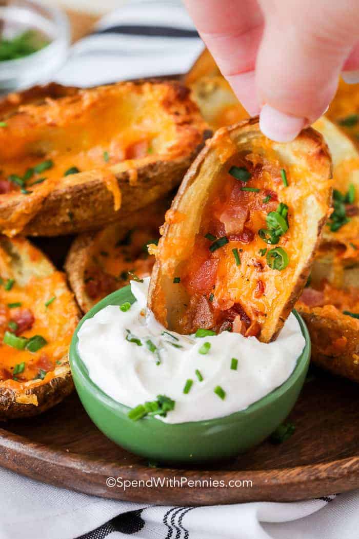 Baked Potato Skins dipped in sour cream