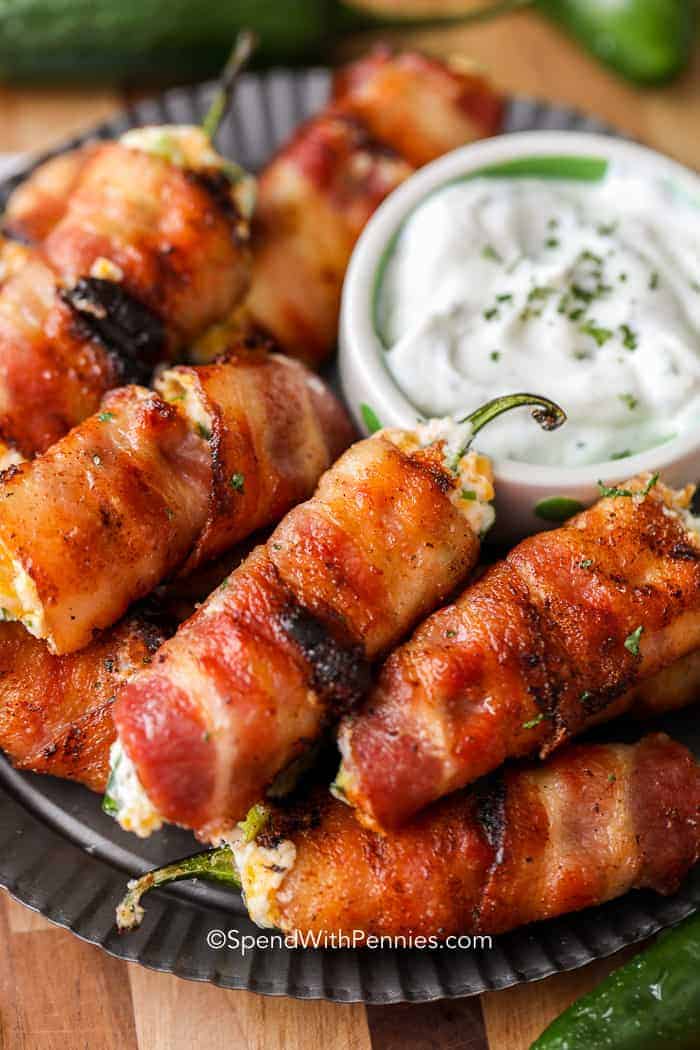 Grilled Bacon Jalapeno Poppers on a plate with dip