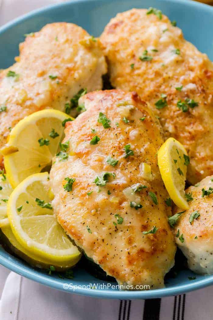 Lemon Pepper Chicken in a blue dish with lemon slices
