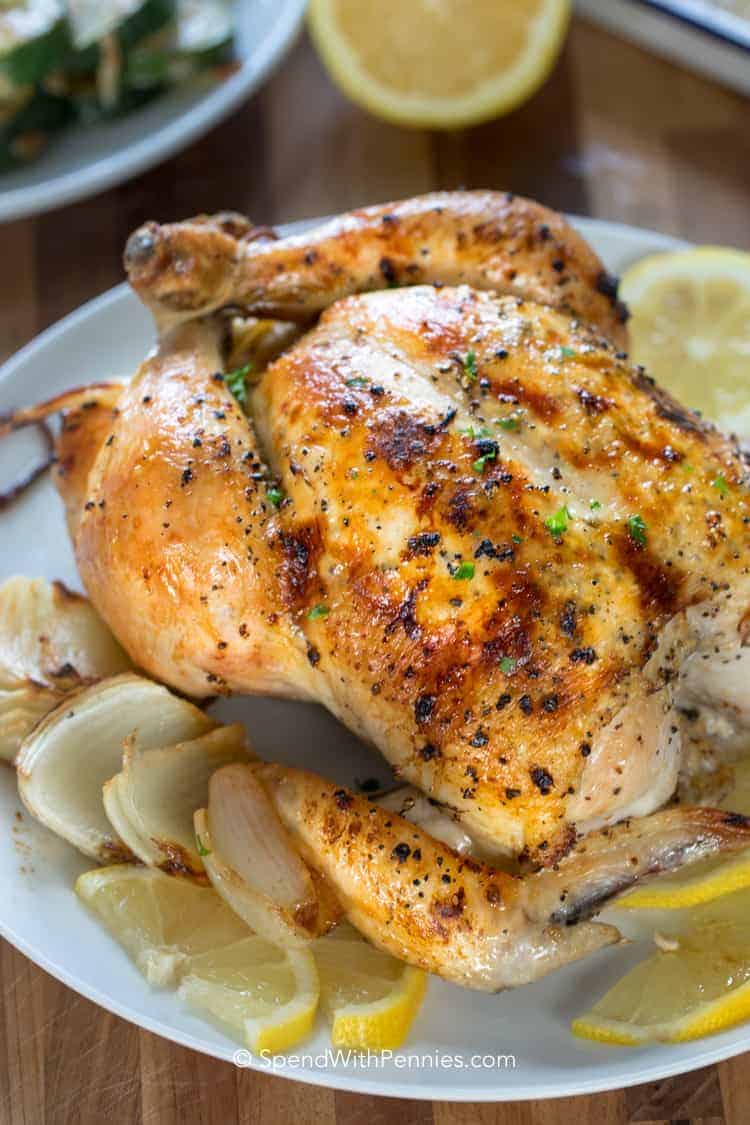 Lemon Roast Chicken on a plate with lemon slices and onion