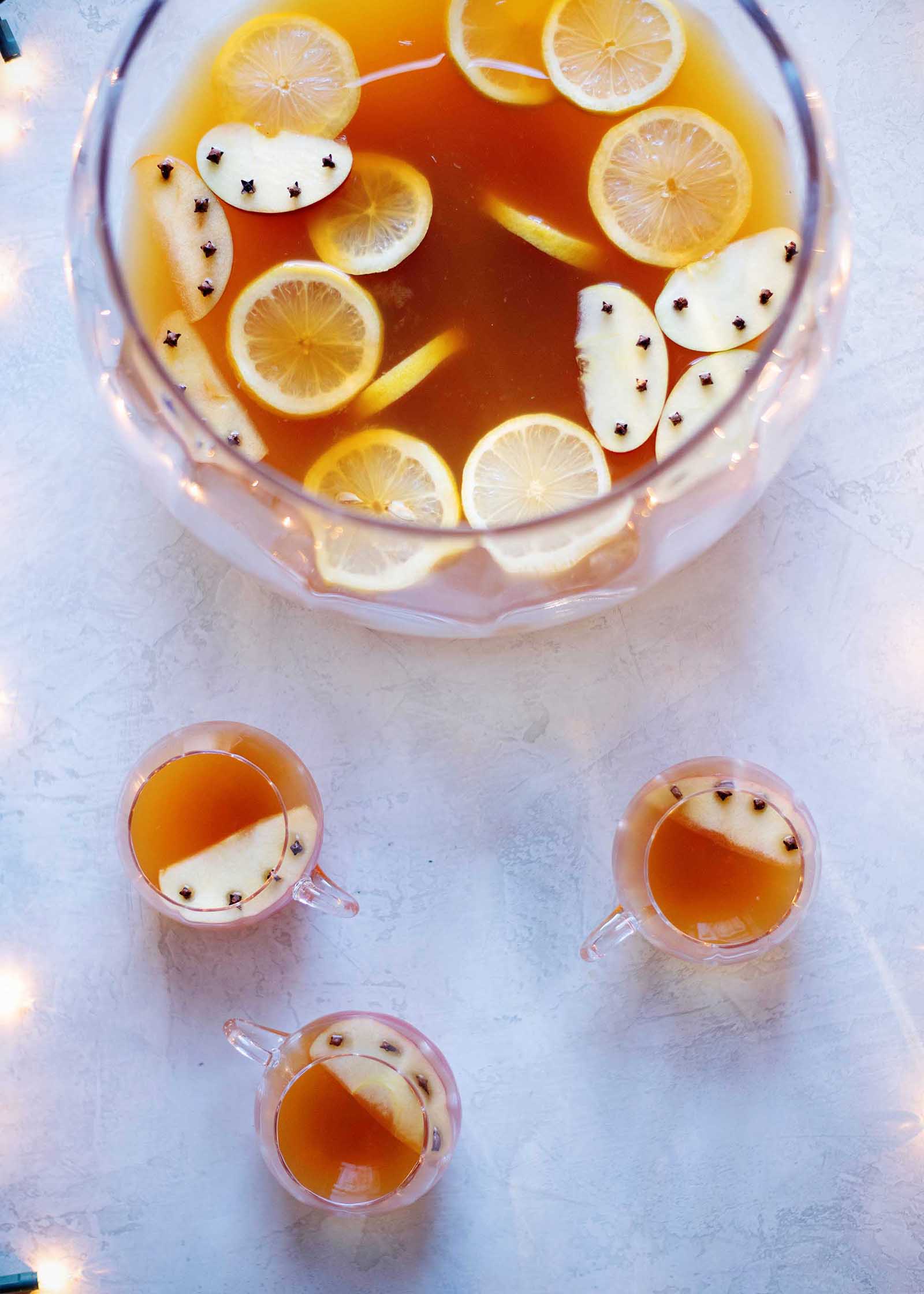 Big bowl of apple cider brandy chai spiced holiday punch