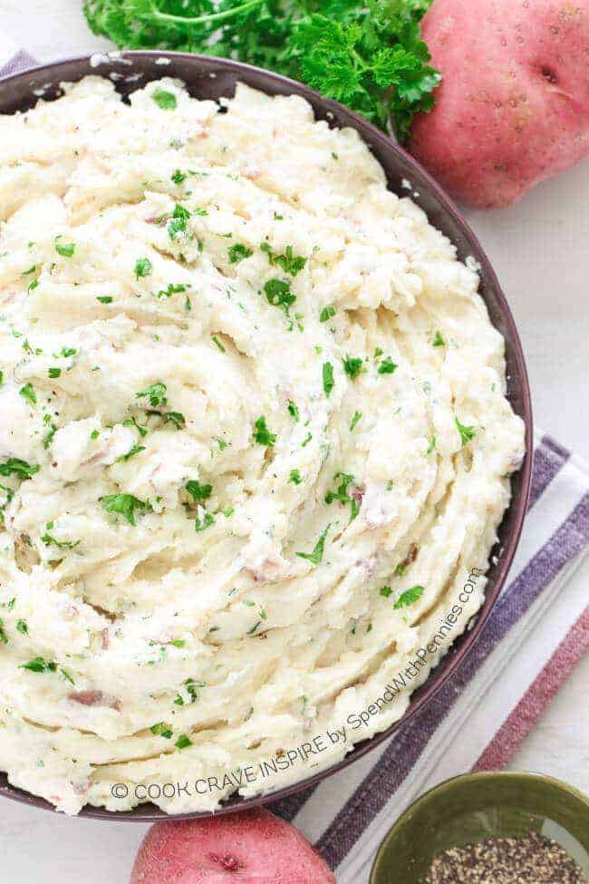 Garlic Ranch Mashed Potatoes with red potatoes next to it