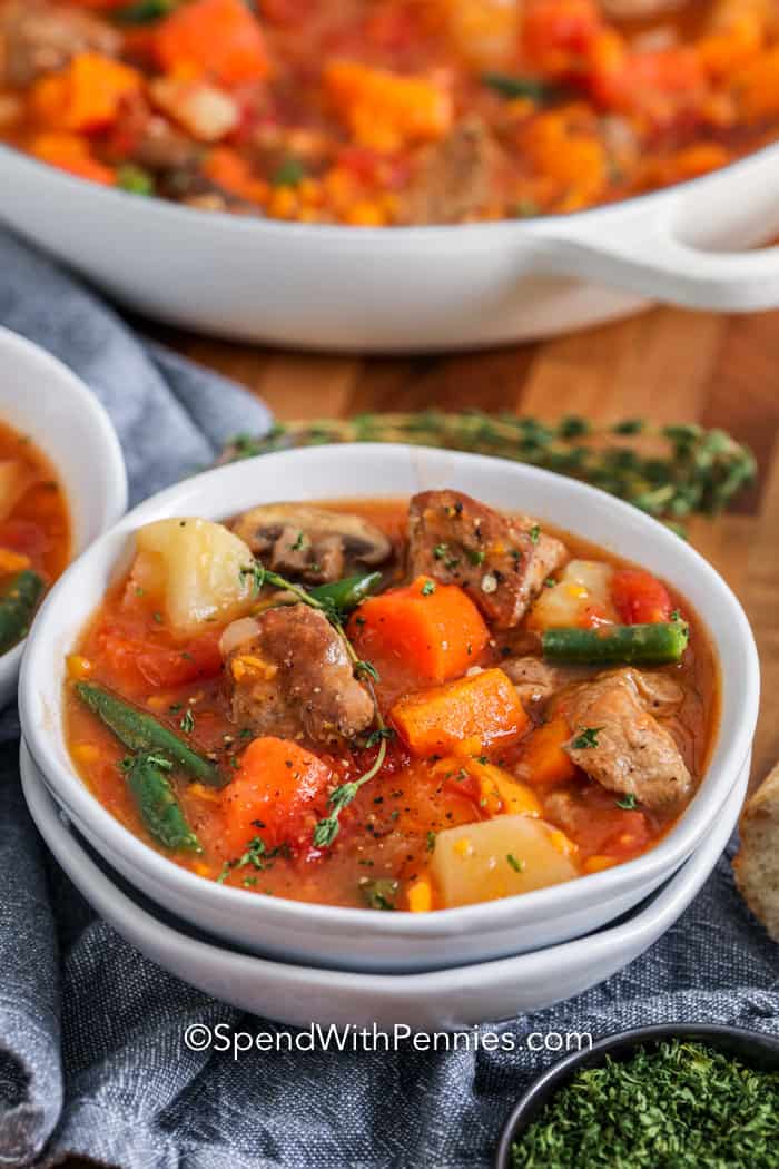 Pork Stew in a white bowl with thyme