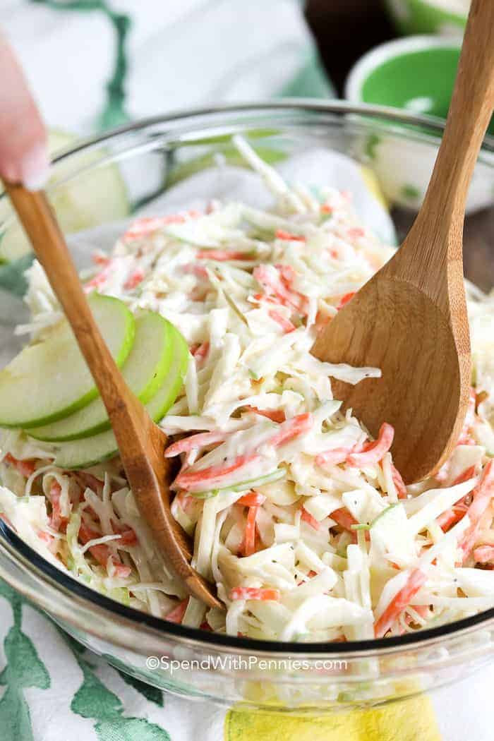 Creamy Apple Slaw in a bowl with wooden spoons