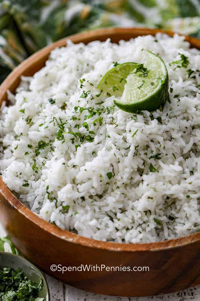 Cilantro Lime Rice in a bowl with lime with a green and yellow napkin