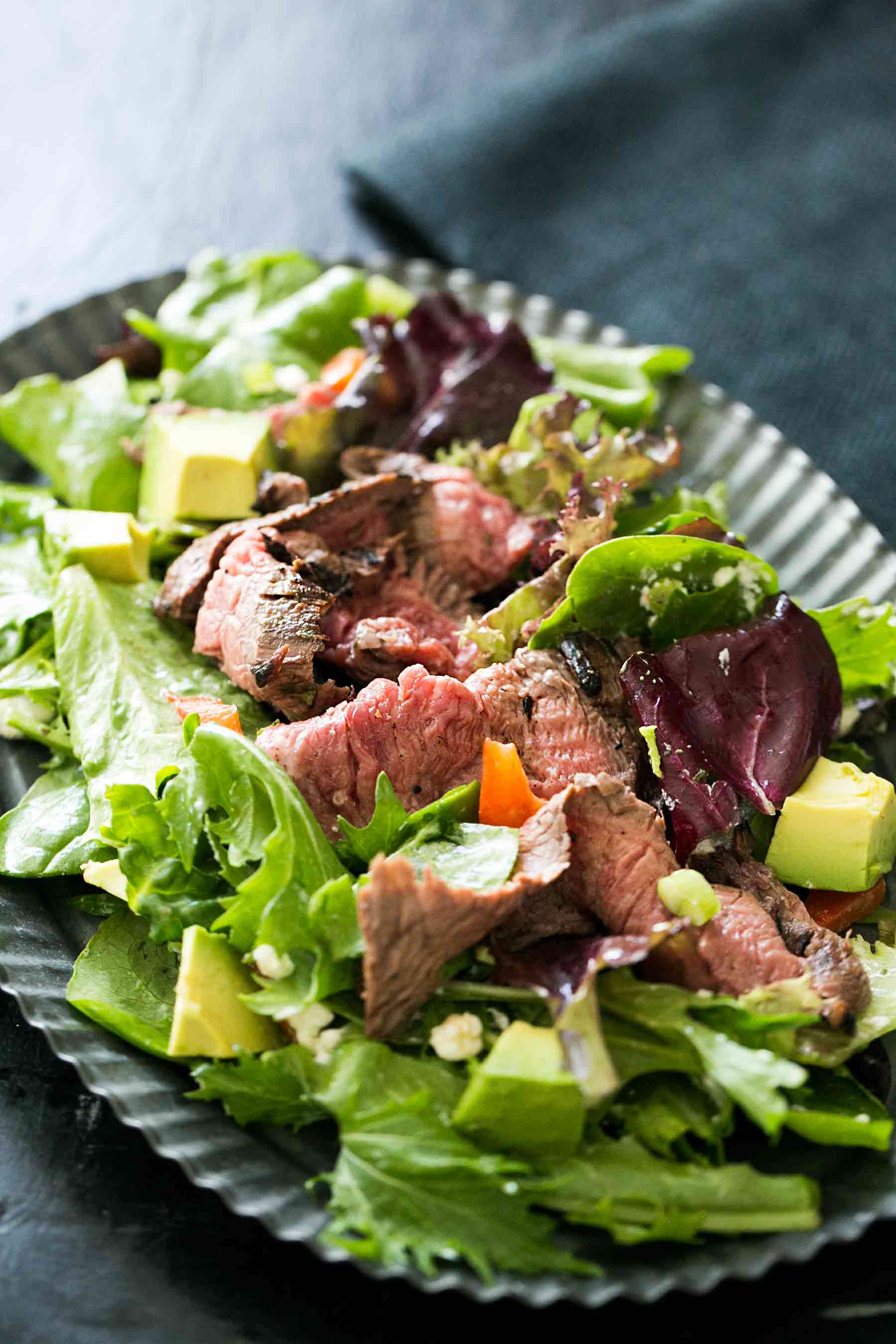 Steak Salad with pan-seared flank steak on a bed of greens and tossed with a lemon vinaigrette