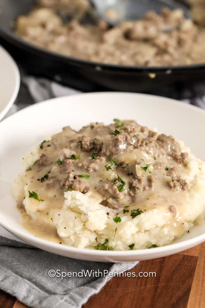 Hamburger gravy on a plate with mashed potatoes and parsley