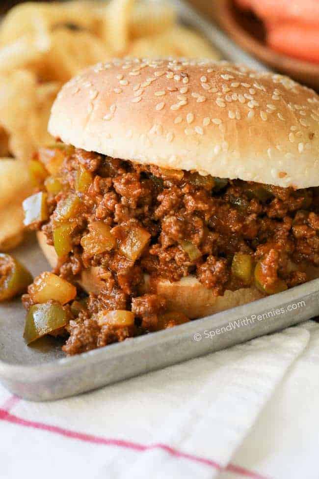 Slow Cooker Sloppy Joes served on a bun on a tray with chips