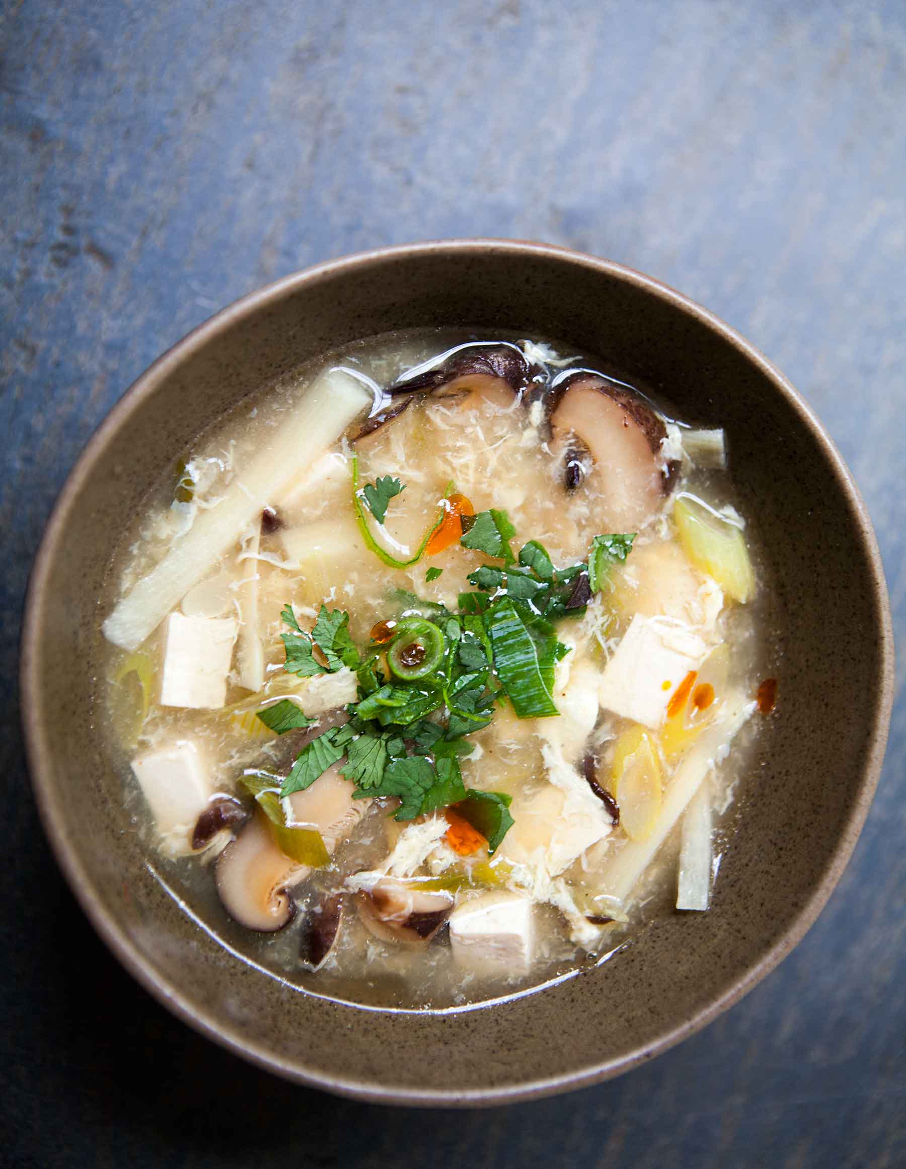 Easy Chinese Copycat Hot and Sour Soup with tofu and mushrooms served in a bowl
