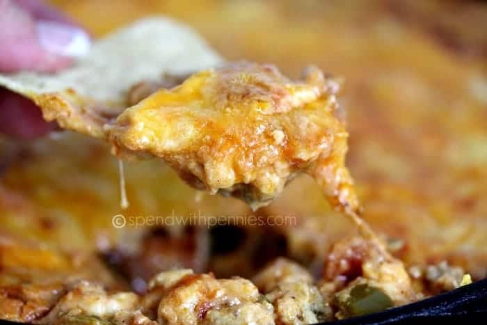hot and cheesy taco dip on a taco chip