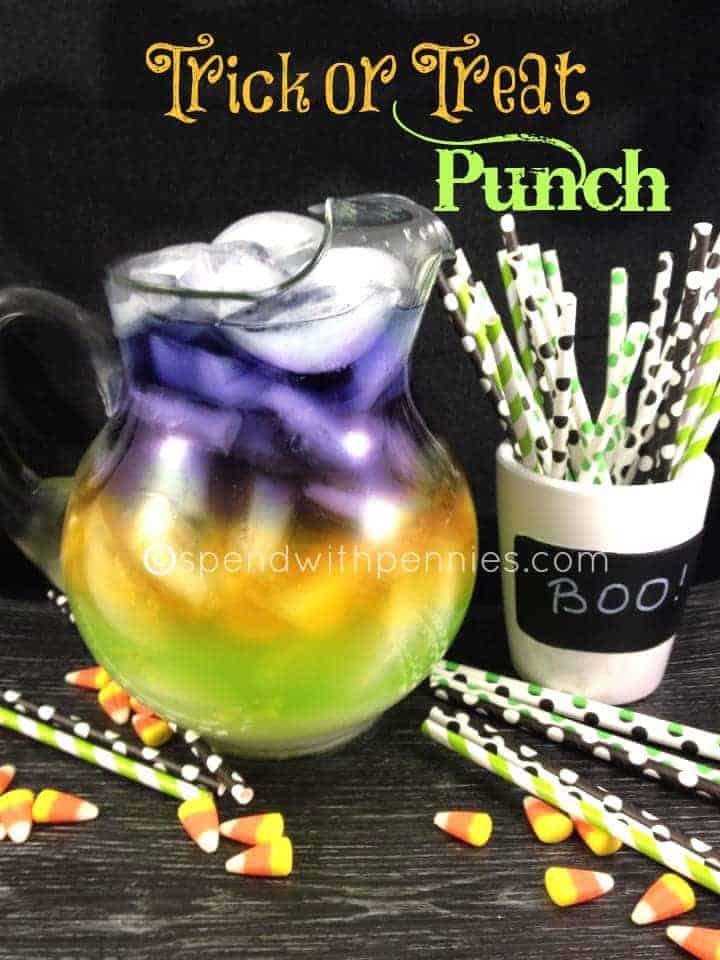 trick or treat punch, purple, orange and green punch in a pitcher with colorful straws on the side