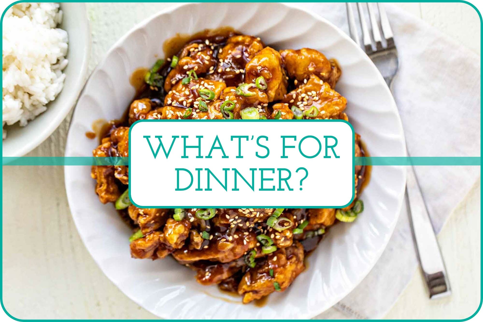 Copy Cat Take Out: White bowl filled with homemade Chinese Orange Chicken. A small bowl of rice is on the side.