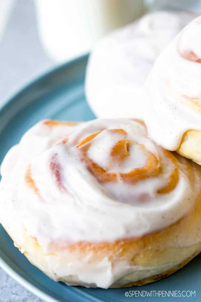 Pumpkin Cinnamon Rolls with cream cheese icing on plate