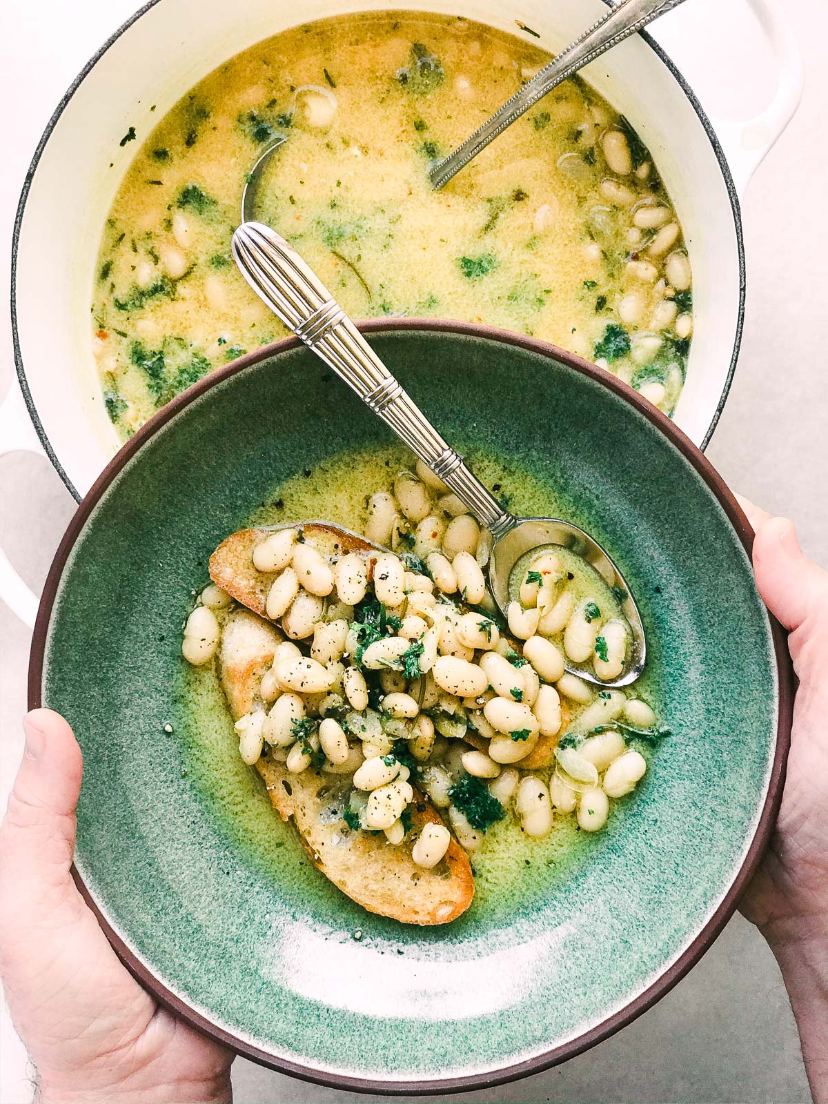 I fagioli con aglio tostano in una ciotola verde