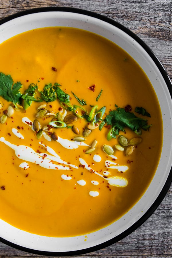 Questa zuppa piccante di zucca tailandese è pronta in soli 30 minuti ed è ricca di sapore. È super cremoso e realizzato con latte di cocco, pasta di curry e tonnellate di altri sapori ispirati alla Thailandia. Servire con tutti gli ingredienti e divorare! 