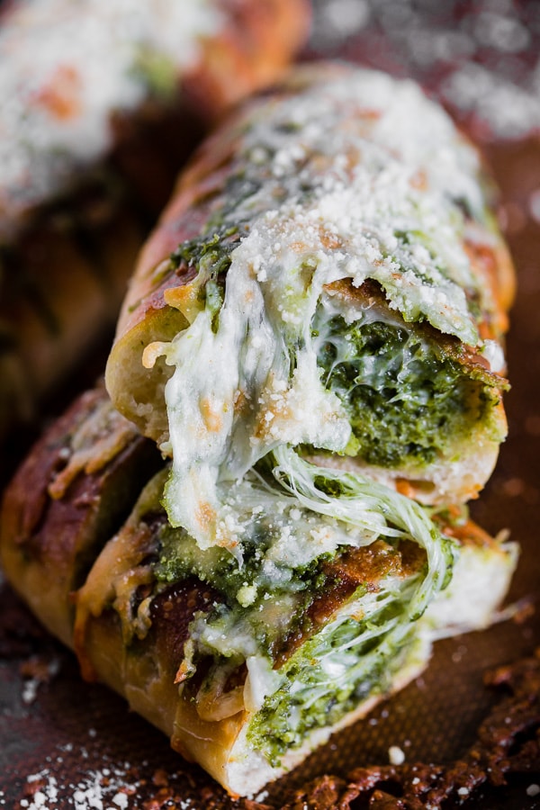 Questo pesto di formaggio e aglio è ripieno di pesto di basilico all'aglio fresco e mozzarella filante. Super semplice da realizzare e pieno di sapore! Amerai quanto è facile preparare questo accompagnamento al pane! 