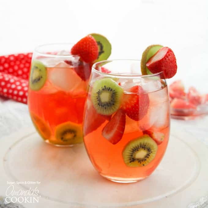 Esta sangría de kiwi y fresa es el cóctel perfecto para el verano, ya sea que lo sirva por la tarde para combatir el calor o como un cóctel divertido para acompañar una barbacoa de verano. Fresa kiwi sangría en copas de vino