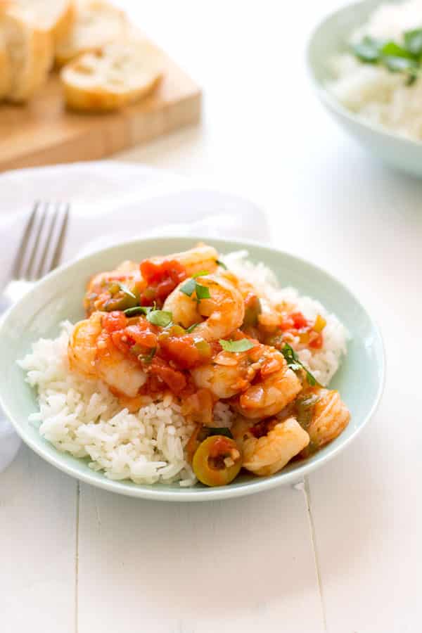 Camarones Guisados - juicy shrimp stewed in a Puerto Rican-style tomato sauce. Loaded with garlic, onions and cilantro, no sofrito needed!