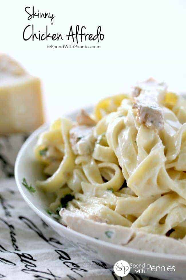 Skinny Chicken Alfredo in a bowl next to a block of parmesan