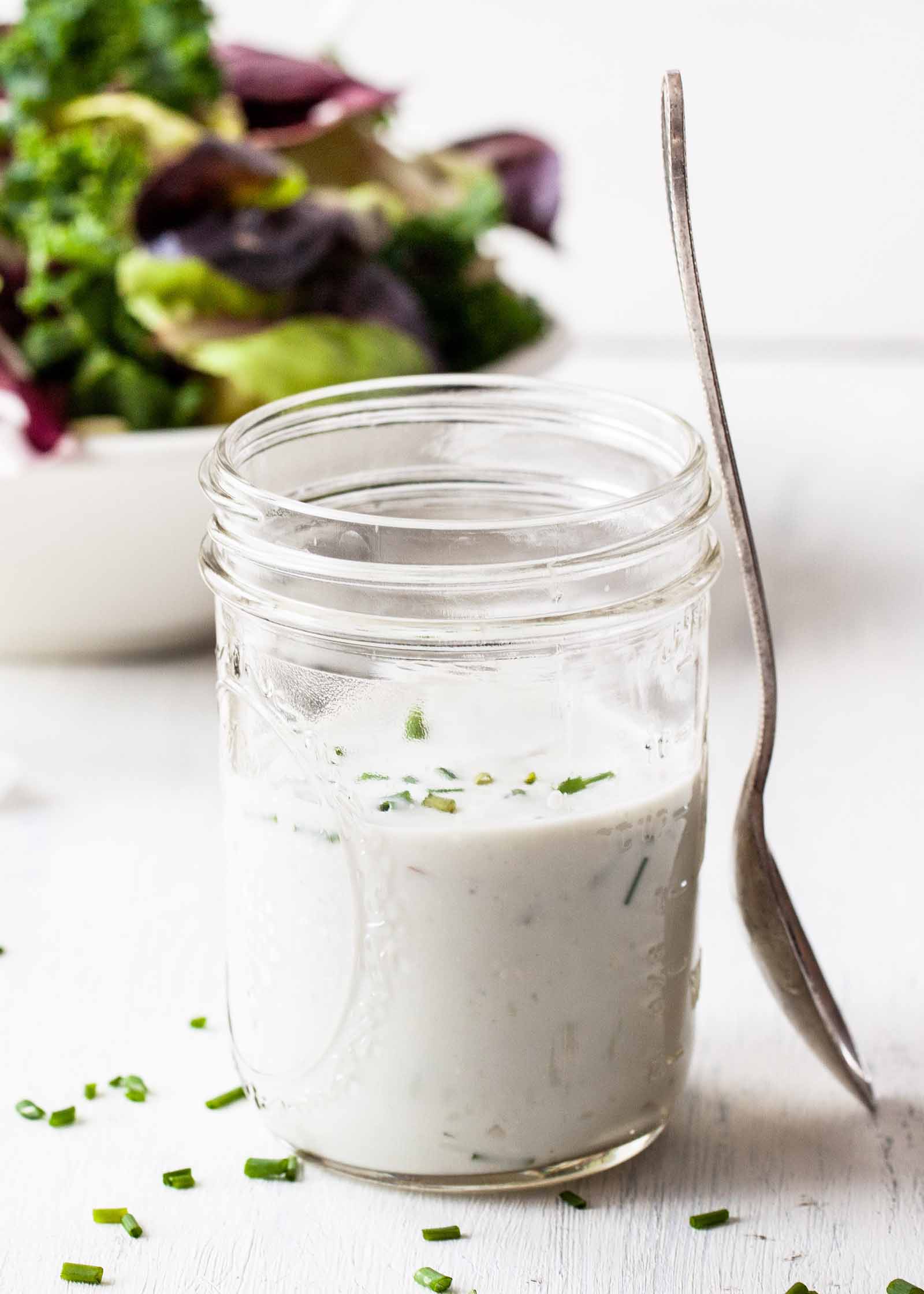 Blue Cheese Salad Dressing - - salad dressing with salad in background.