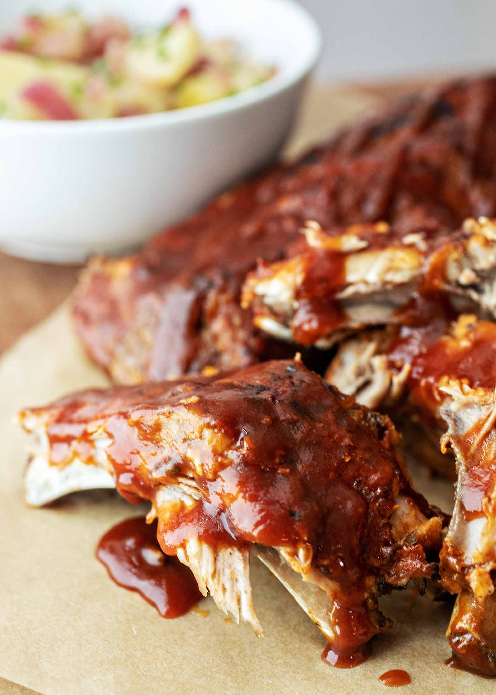 Juicy Pressure Cooker BBQ Ribs with sauce and potato salad