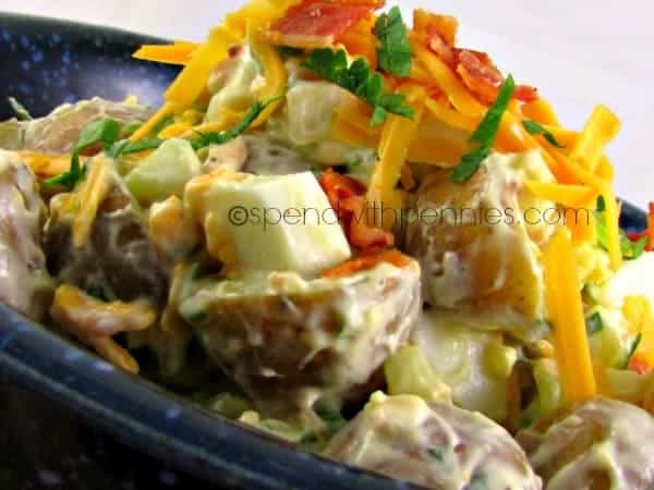 warm bacon cheddar potato salad topped with cheese and bacon