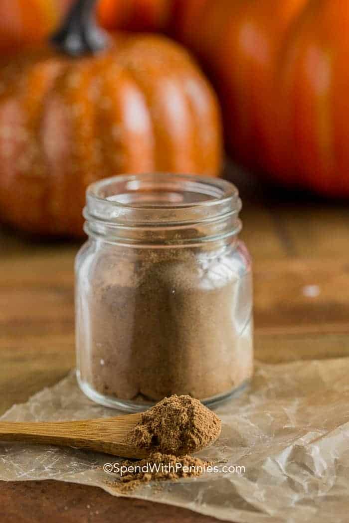 Jar of Pumpkin Pie Spice with pumpkins in the background