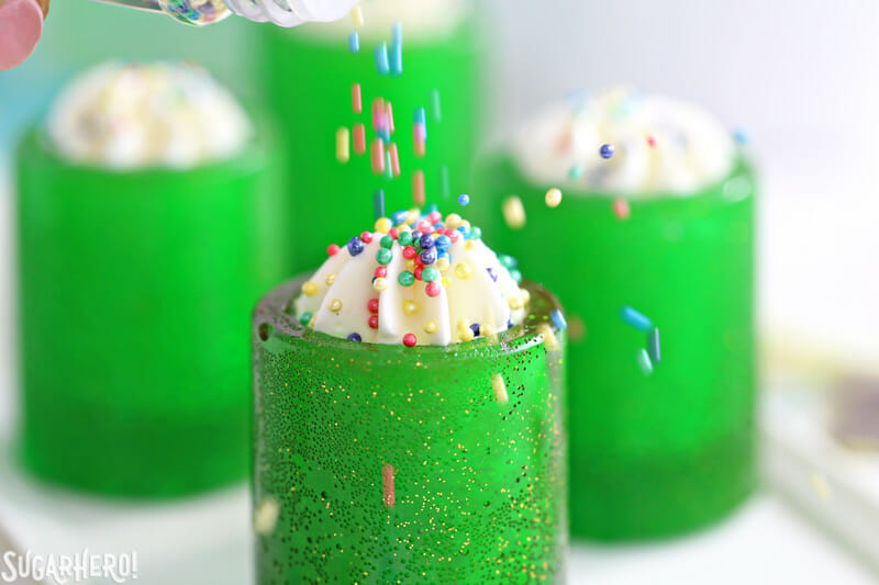 Copos para doces DIY: Agora você pode fazer seus próprios copos comestíveis com açúcar! Encha-os com sua bebida favorita, chantilly, mousse ou o que quiser! O | From SugarHero.com Copos para doces de bricolage - derramando faíscas sobre o chantilly em um copo de caramelo | From SugarHero.com