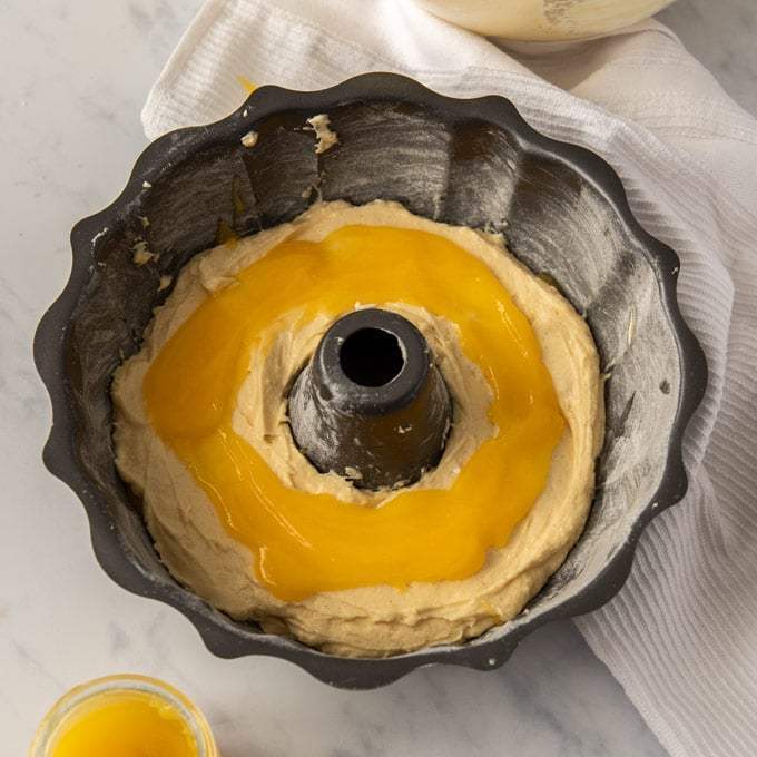 Um pacote de lata com uma camada de massa de bolo, coberta com uma camada de coalhada de limão