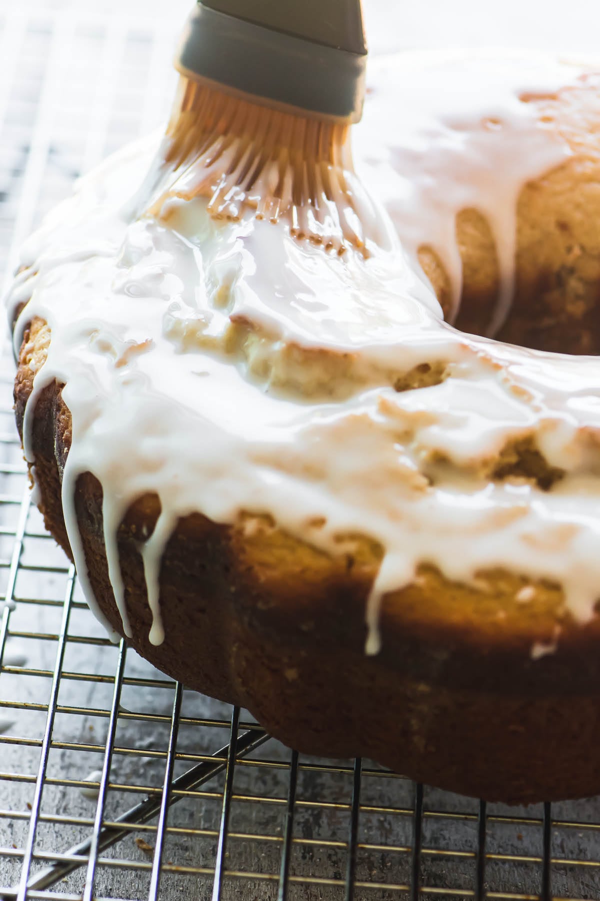 Pincele o esmalte sobre um bolo antiquado de manteiga com rosquinha