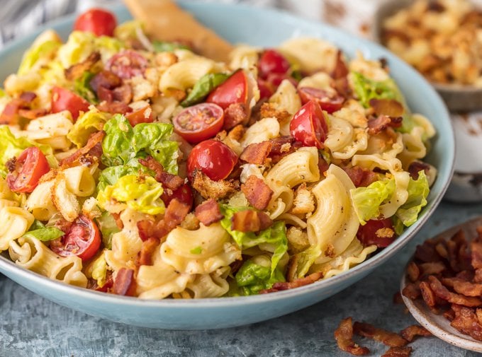 Esta receita de salada de macarrão BLT é carregada com tomates suculentos, bacon crocante, alface fresca e pequenos croutons assados. A salada de macarrão BLT é misturada com um molho de maionese com sabor e é a melhor receita de salada de macarrão de verão. Churrascos, festas e celebrações de férias, como 4 de julho, precisam deste prato incrível.