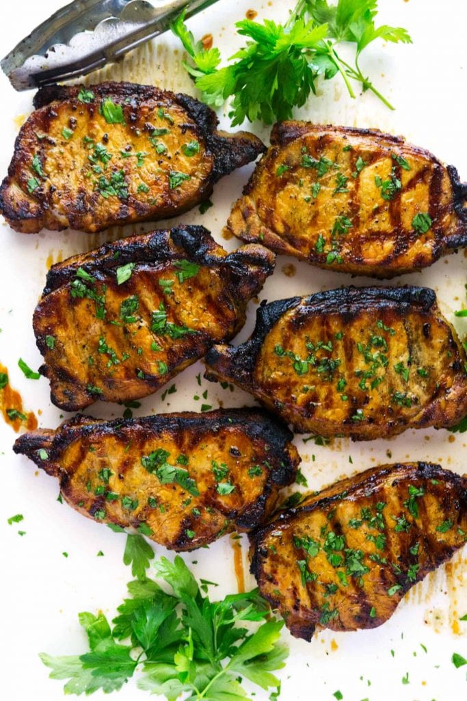 These super easy marinated grilled pork chops are marinated in soy, chicken broth, and spices then grilled to perfection. 
