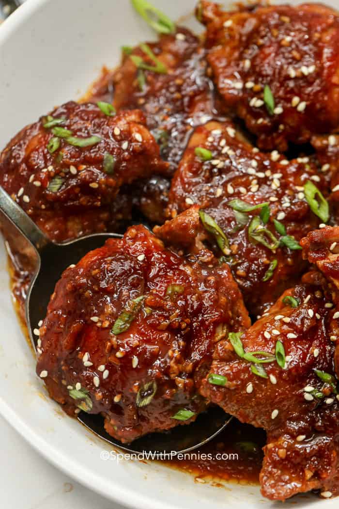 Crock Pot Chicken Thighs garnished with green onions and sesame seeds