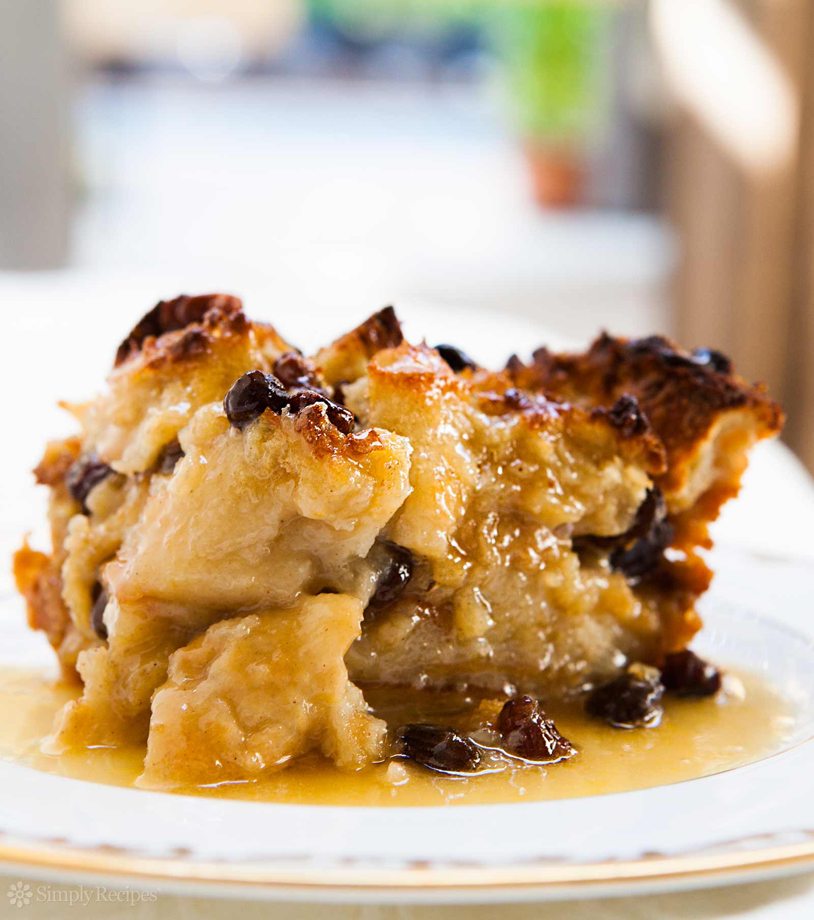 Best Bread Pudding on a white plate covered with bourbon sauce