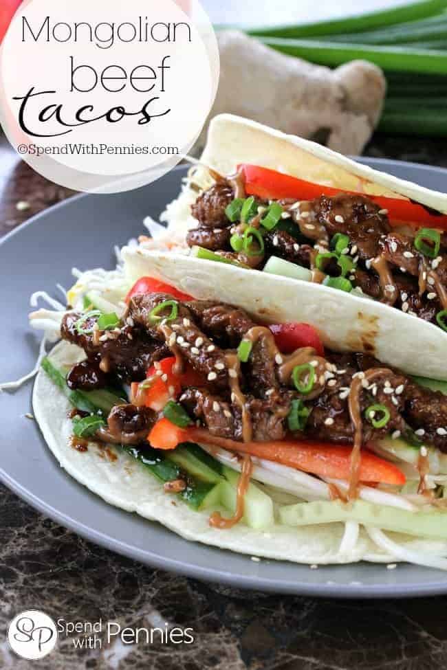 two Mongolian beef tacos on a blue plate