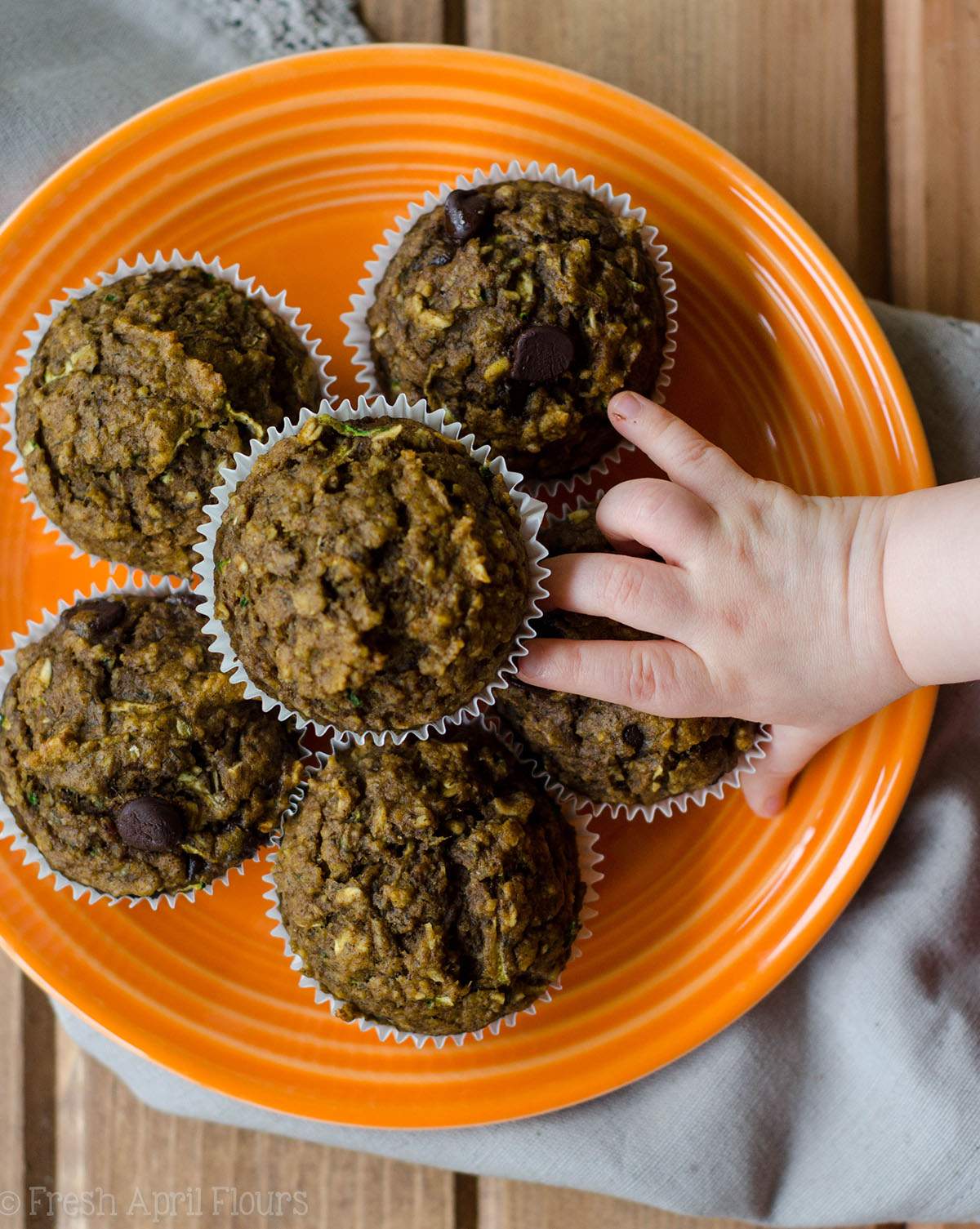 Toddler Muffins: Whole wheat muffins made with shredded zucchini and pureéd pumpkin, sweetened with mashed bananas, applesauce, and minimal sugar. Suitable for toddlers, children, and adults!