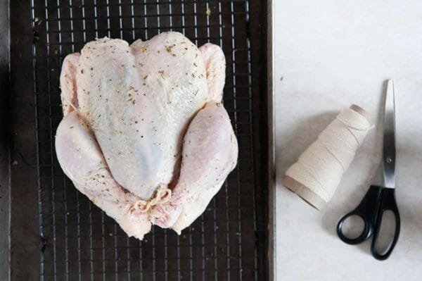 Cómo asar un pollo entero: pollo entero crudo y guita de carnicero