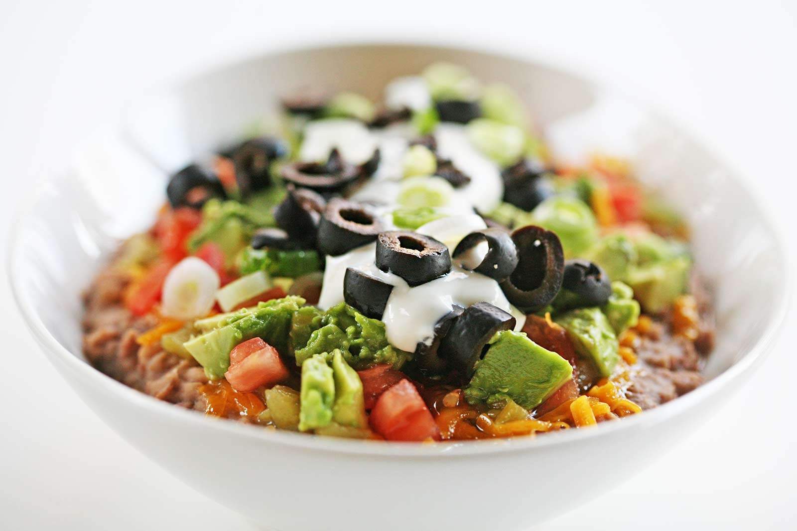 Completed 7 Layer Bean Dip Recipe in Large White Bowl